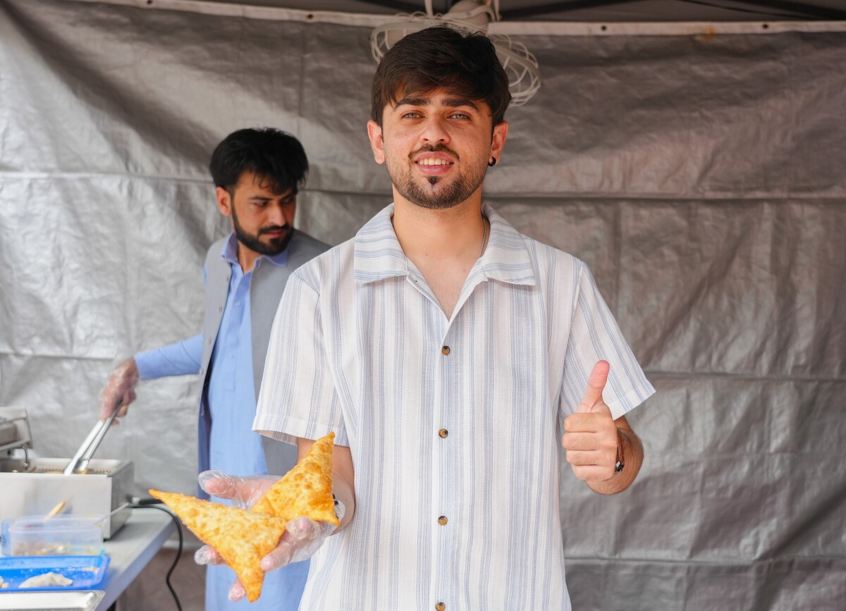 Pakistani students prepare freshly fried samosas, filling the air with rich aromas.Image