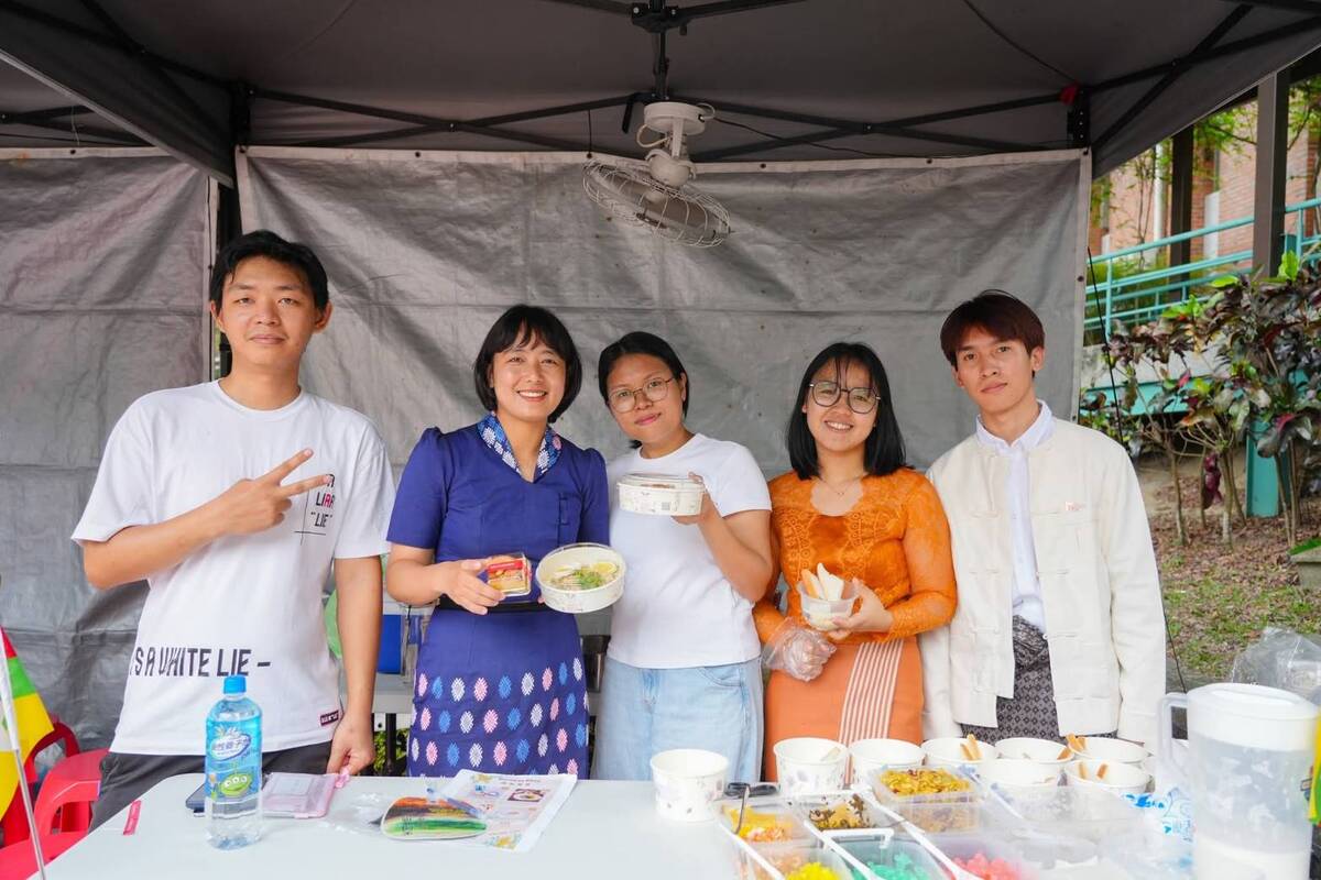 Myanmar students present traditional dishes, including sweet potato pudding and tea leaf salad.Image