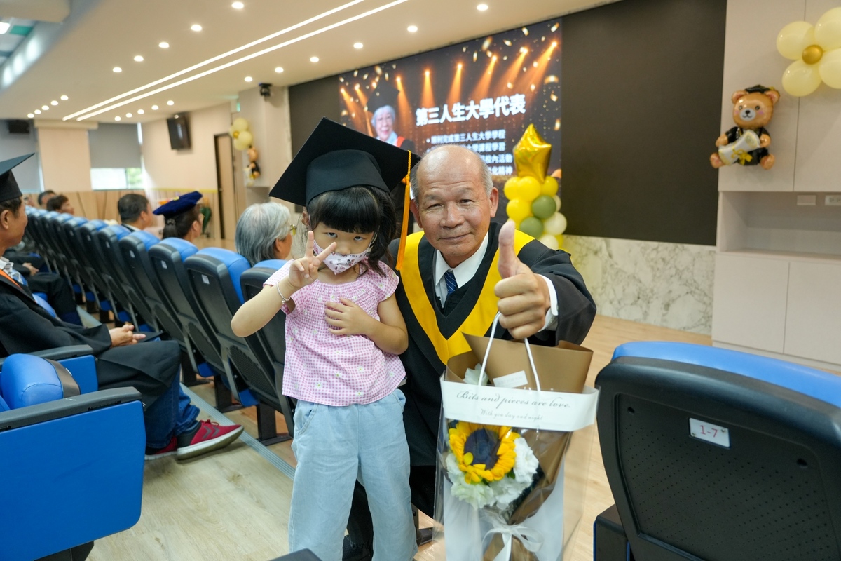 A granddaughter joined the celebration, sharing in her grandfather's joy.Image