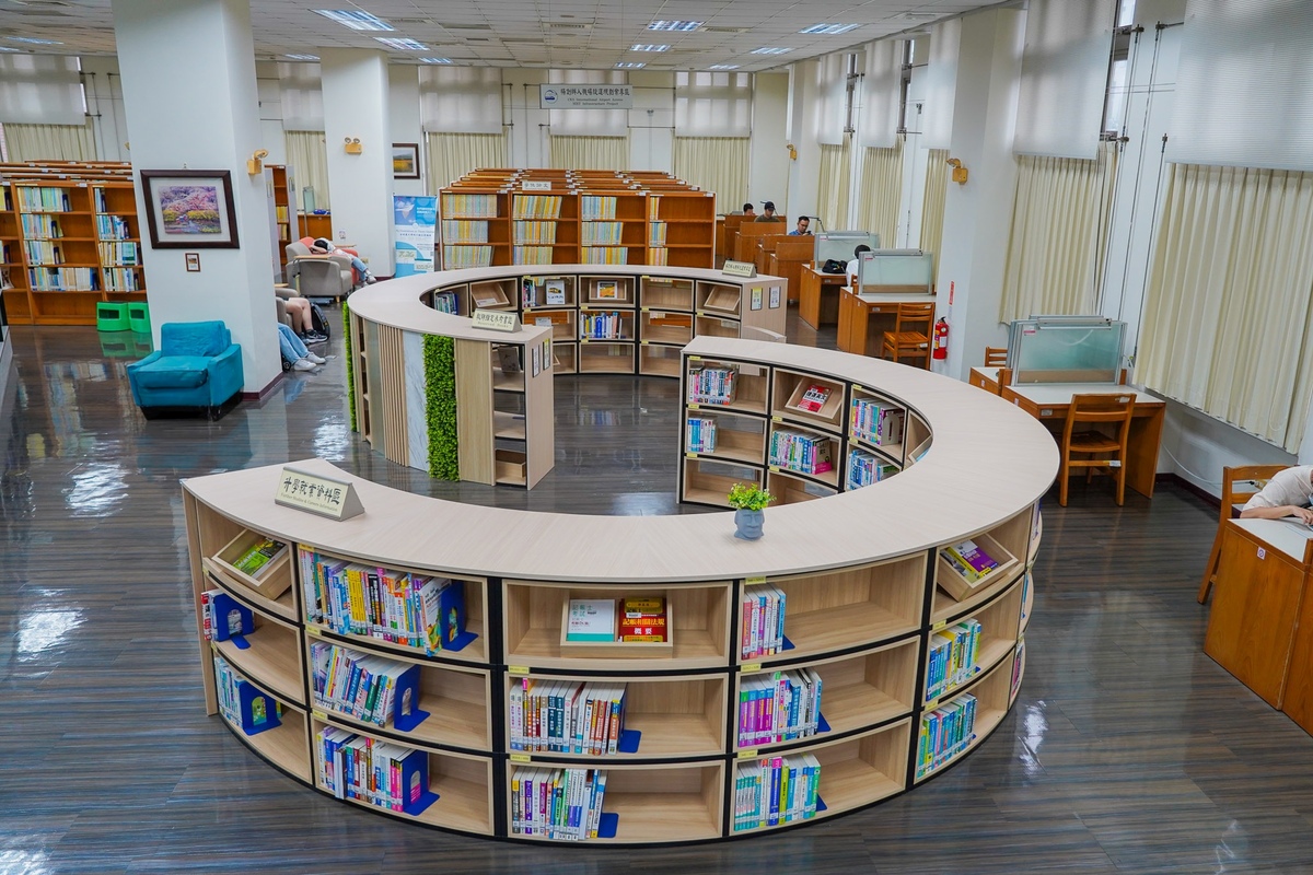 The library's study and career resources section features an S-shaped bookshelf layout, enhancing flow while incorporating sustainable design elements.Image