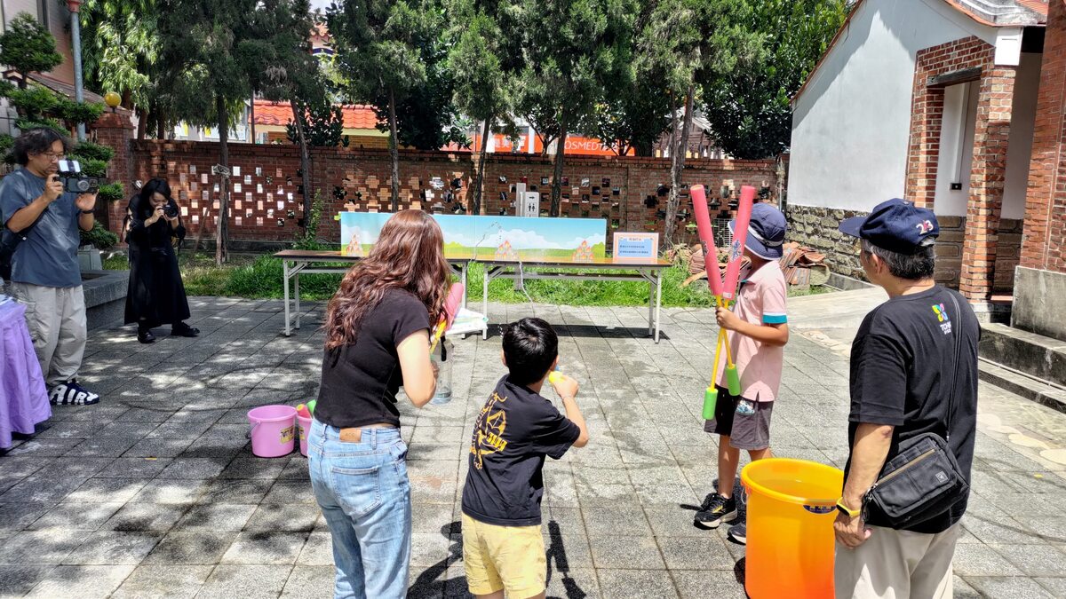 The firefighting game introduced participants to the pond's traditional fire-prevention function.Image